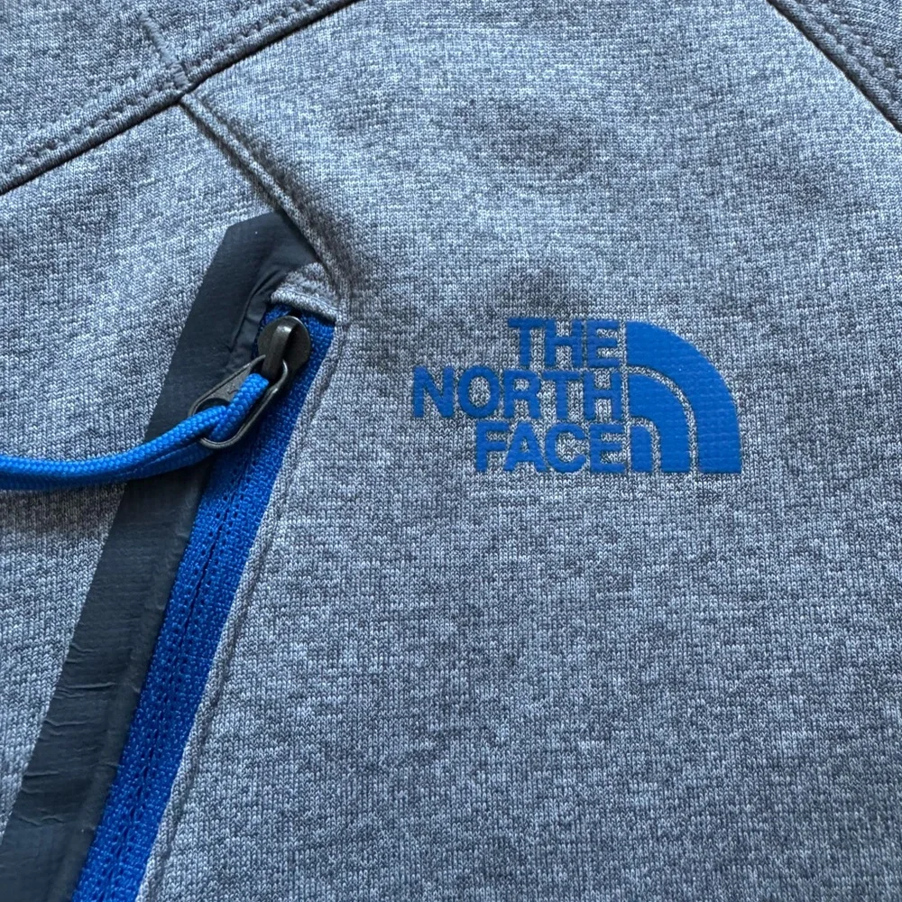 The North Face Men’s gray quarter zip with blue details.  Size medium